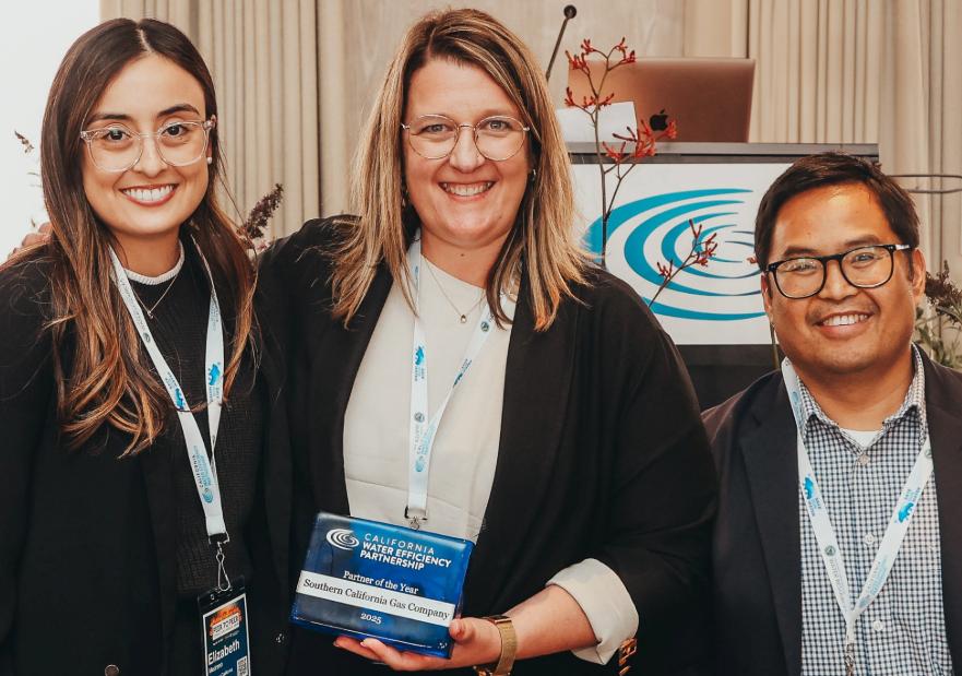 SoCalGas Team members holding award with Tia Fleming from CalWEP